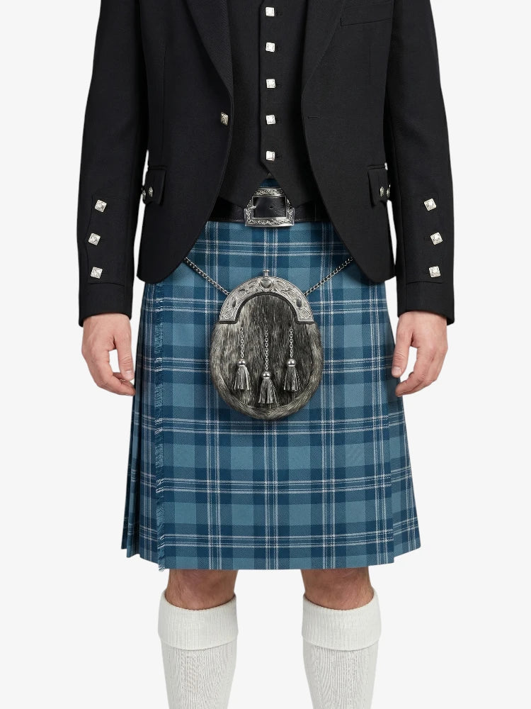 Person wearing a black jacket, blue plaid kilt, and white knee-high socks on a white background