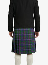 Person wearing a black jacket and a green plaid kilt on a white background