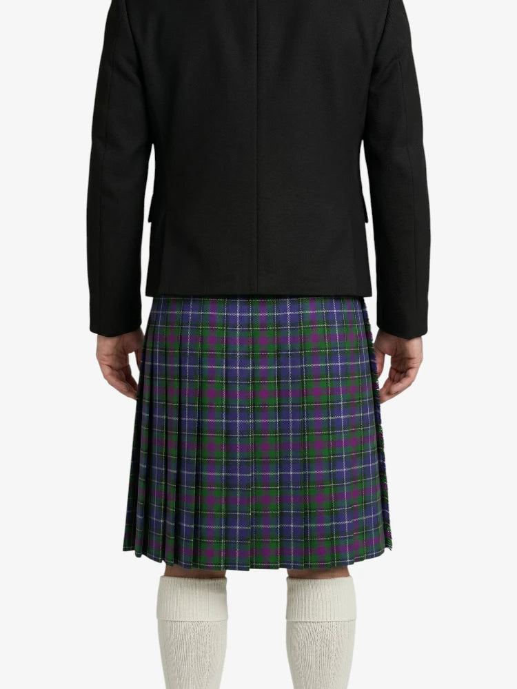 Person wearing a black jacket and a green plaid kilt on a white background