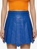 Blue pleated skirt worn by a person on a white background