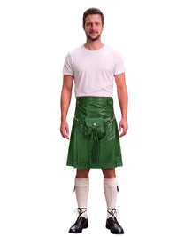 A man modeling a green faux-leather kilt with a matching belt and pouch, styled with a white t-shirt, white knee-high socks, and black shoes against a white background.