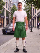 A man stands on a city sidewalk wearing a white crew-neck t-shirt and a green leather kilt with a drawstring waist, paired with white knee-high socks and black leather shoes. A black Mercedes-Benz car and a bicycle are visible in the background of the street scene.