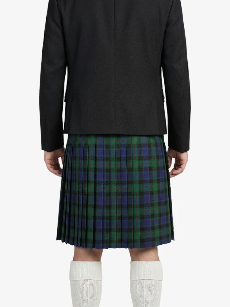 Person wearing a black jacket and green plaid kilt on a white background