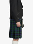 Person wearing a black blazer and green plaid kilt on a white background