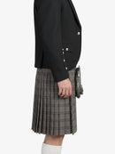 Person wearing a black jacket and gray plaid kilt on a white background