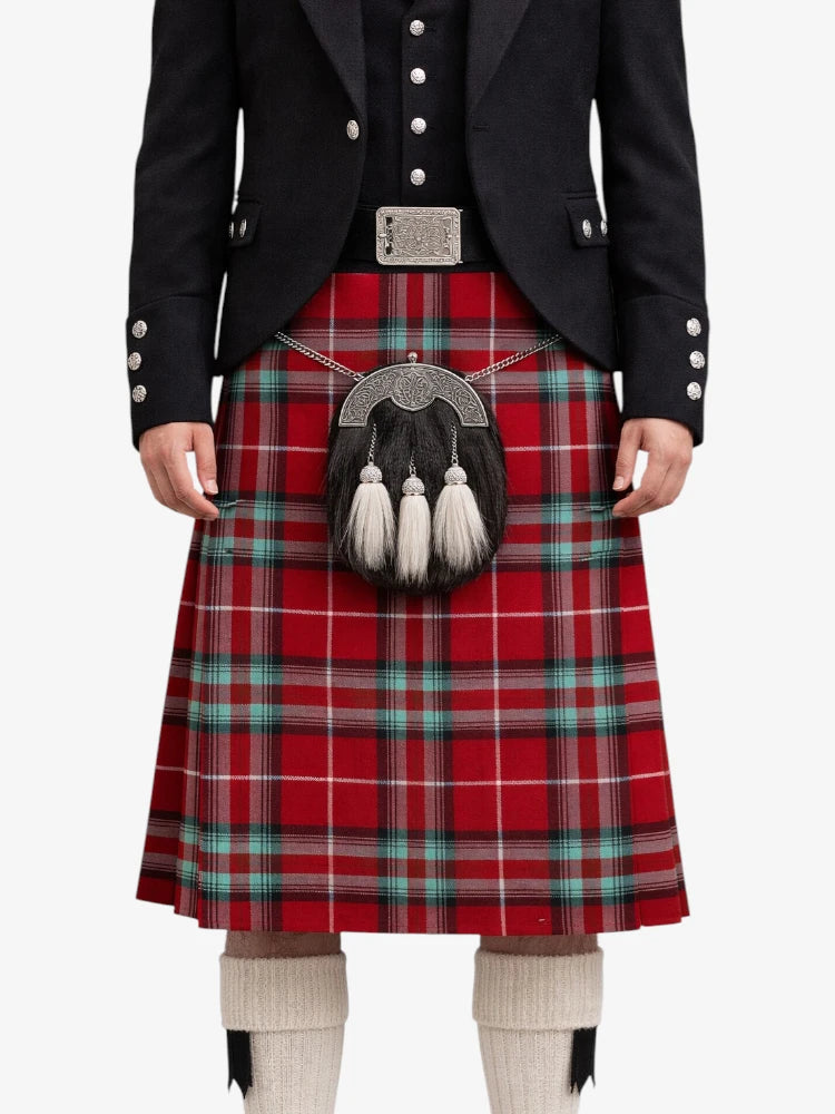 Person wearing a red tartan kilt with a black jacket on a white background