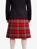 Person wearing a black jacket and red plaid kilt on a white background