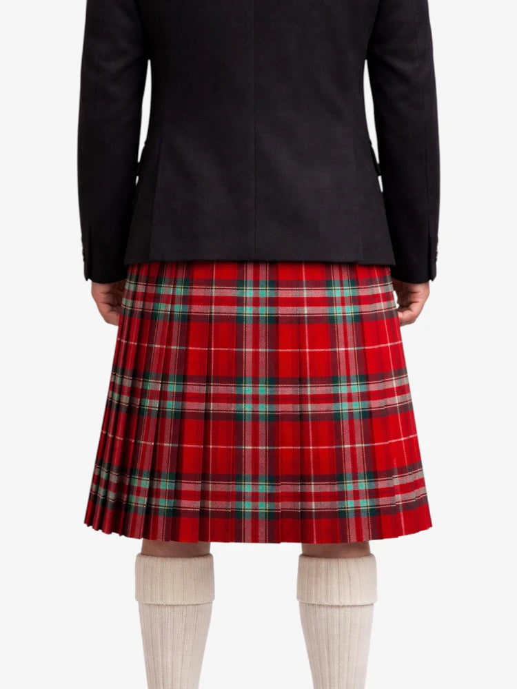 Person wearing a black jacket and red plaid kilt on a white background