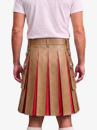 A man wearing a tan pleated leather kilt with red lining and silver-tone decorative hardware, paired with a light pink t-shirt, shown from the back against a light gray background.