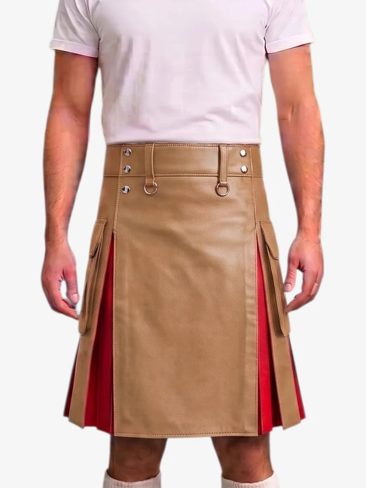 A man wearing a tan faux-leather kilt with red pleated side panels and a matching belt, paired with a light pink t-shirt against a white background.