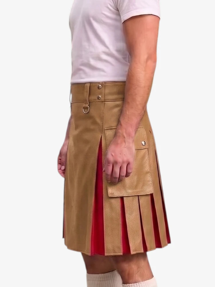 A man wearing a tan faux-leather kilt with pleated red lining and silver-tone hardware, paired with a white t-shirt and white socks, shown from the waist down against a light gray background.