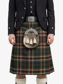 Person wearing a traditional Scottish kilt with a tartan pattern on a white background