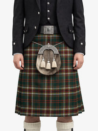Person wearing a traditional Scottish kilt with a tartan pattern on a white background