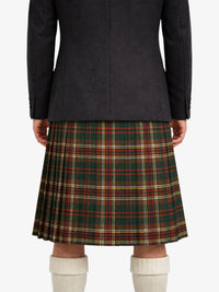 Person wearing a dark coat and plaid kilt on a white background