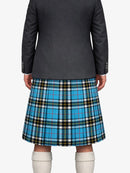 Person wearing a gray blazer and blue plaid kilt on a white background