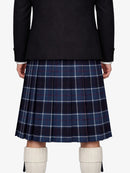 Person wearing a dark coat and blue plaid kilt with white knee-high boots on a white background