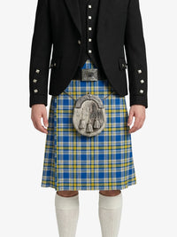 Person wearing a blue and yellow plaid kilt with a black jacket on a white background
