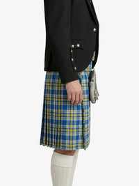 Person wearing a black blazer and blue plaid kilt on a white background