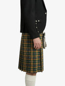 Person wearing a black jacket and green plaid kilt on a white background