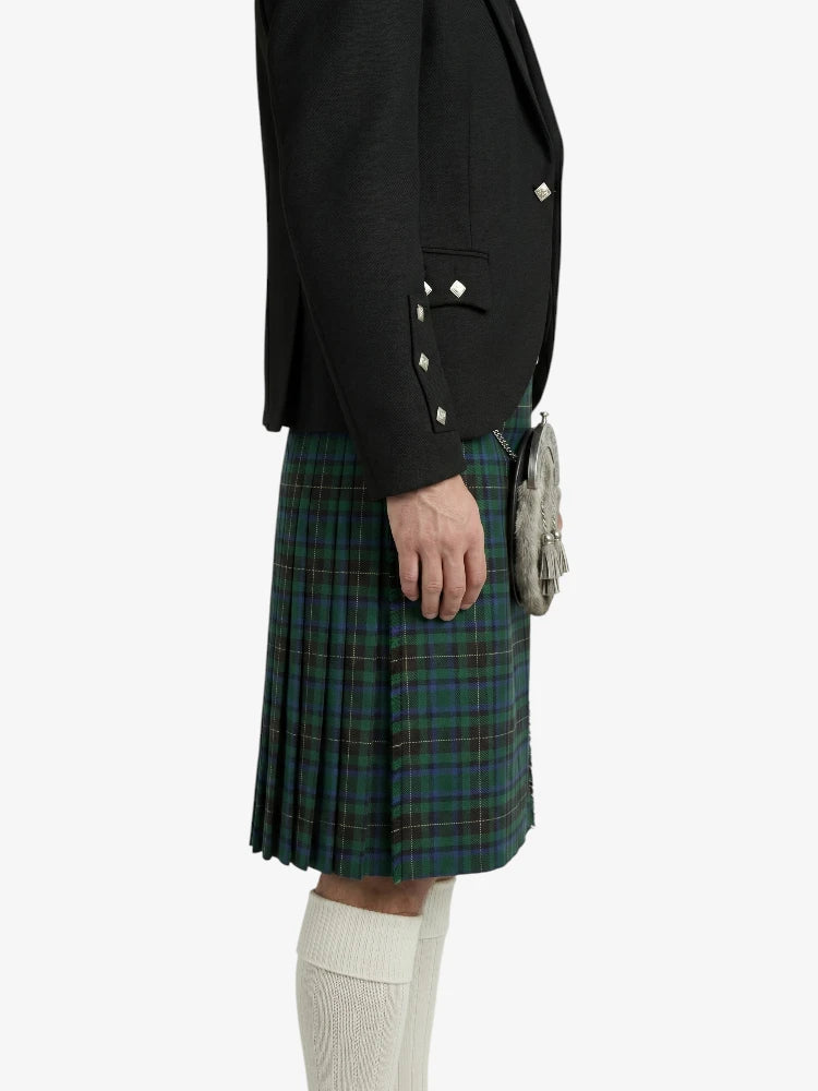 Person wearing a black blazer and plaid kilt on a white background