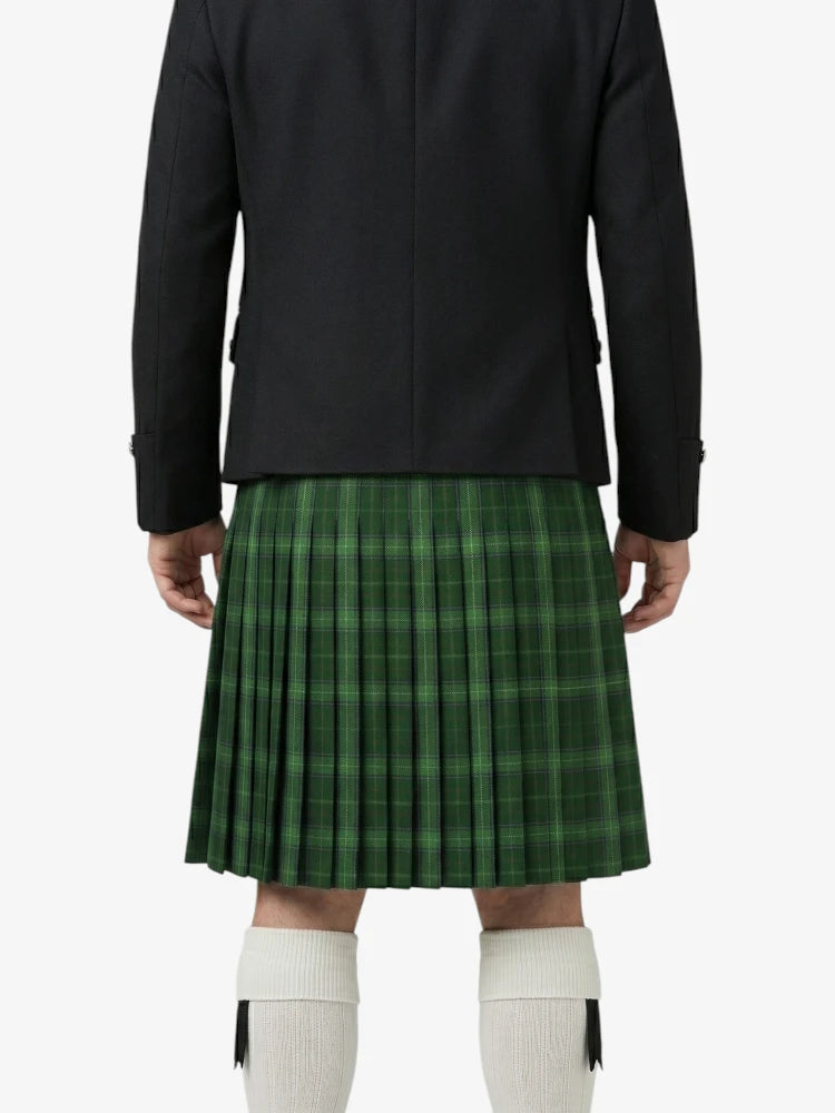 Person wearing a black jacket and green plaid kilt on a white background