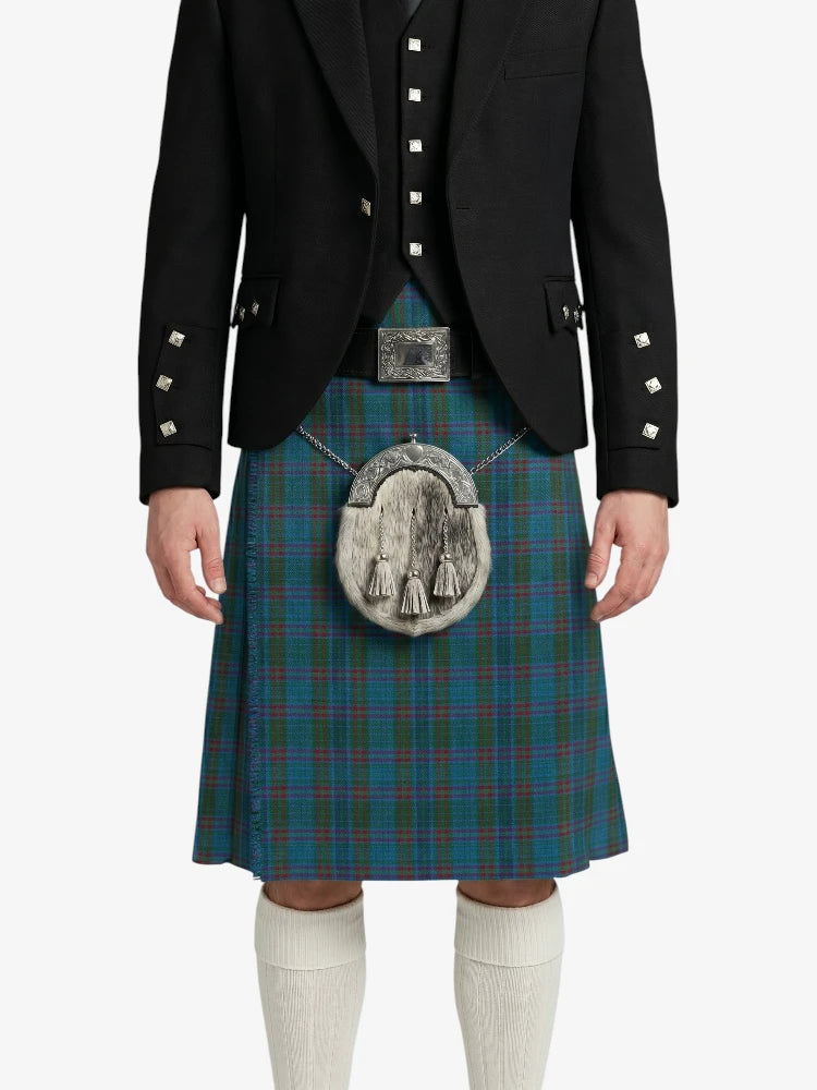 Person wearing a traditional Scottish kilt with a jacket on a white background