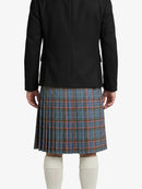 Person wearing a black jacket and blue plaid kilt on a white background