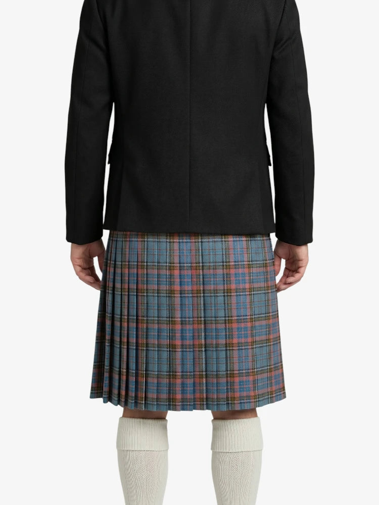 Person wearing a black jacket and blue plaid kilt on a white background