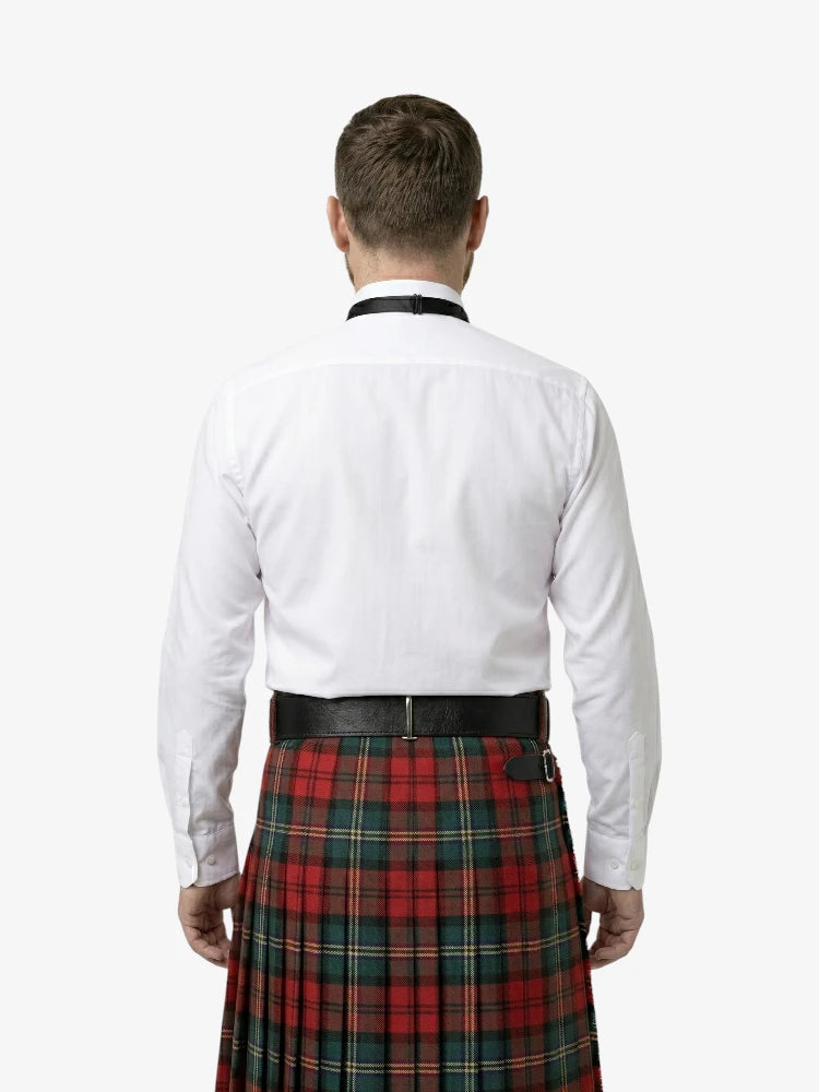 Man wearing a white shirt and red plaid kilt on a white background