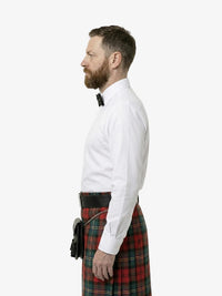 Man wearing a white shirt and red plaid kilt on a white background