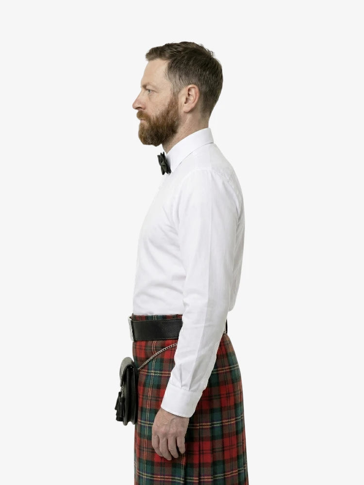 Man wearing a white shirt and red plaid kilt on a white background