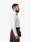 Man wearing a white shirt and red plaid kilt on a white background