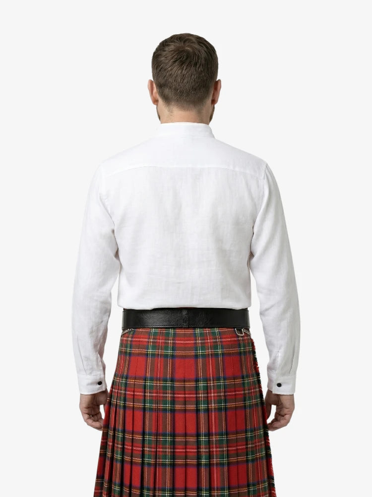 Man wearing a white shirt and red plaid kilt on a white background