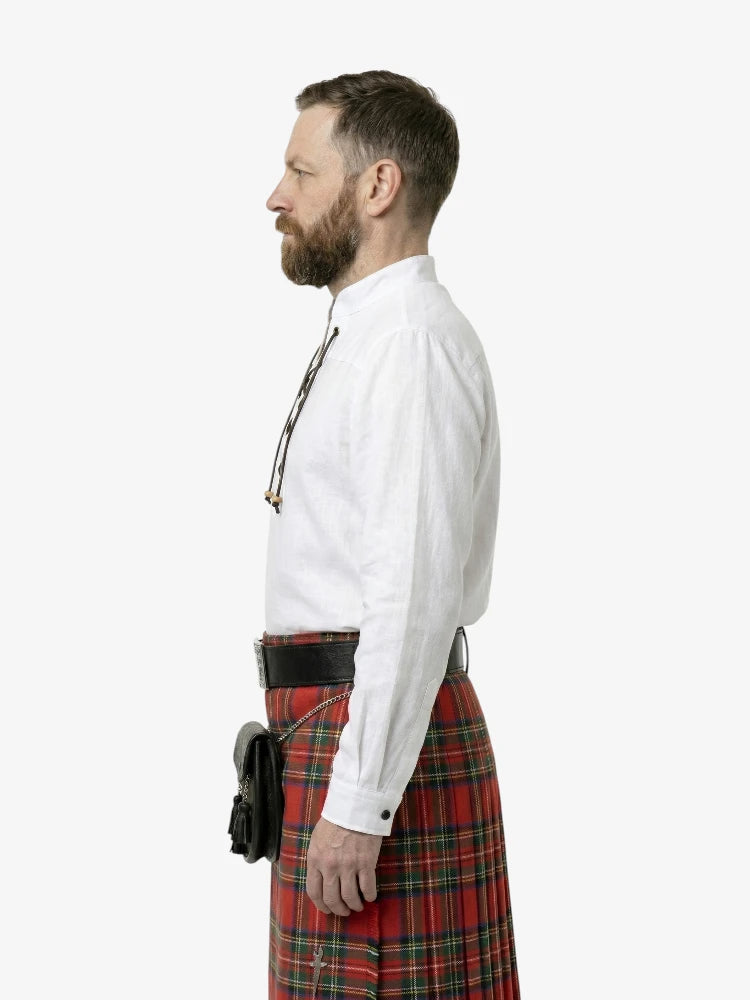 Man wearing a white shirt and red plaid kilt on a white background
