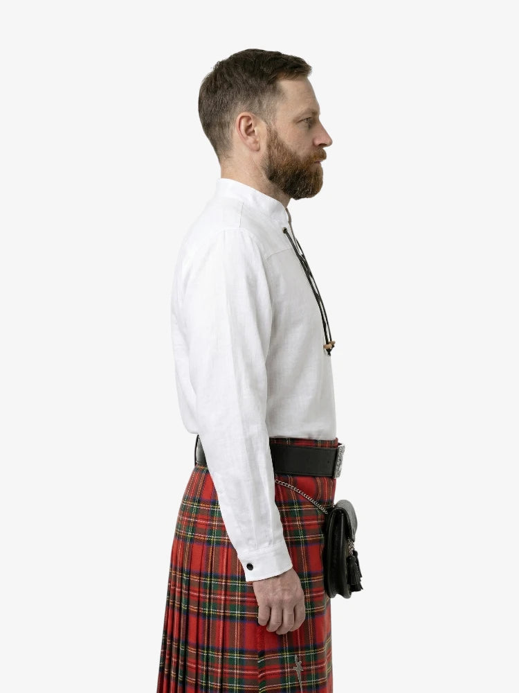 Man wearing a white shirt and red plaid kilt on a white background