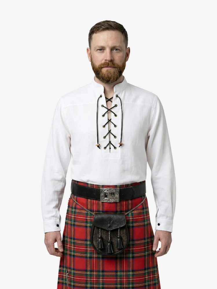 Man wearing a white shirt with lace-up front and a red plaid kilt on a white background