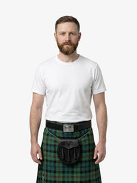 Man wearing a green plaid kilt with a white shirt on a white background