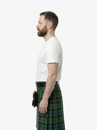 Man wearing a green plaid kilt and white shirt on a white background