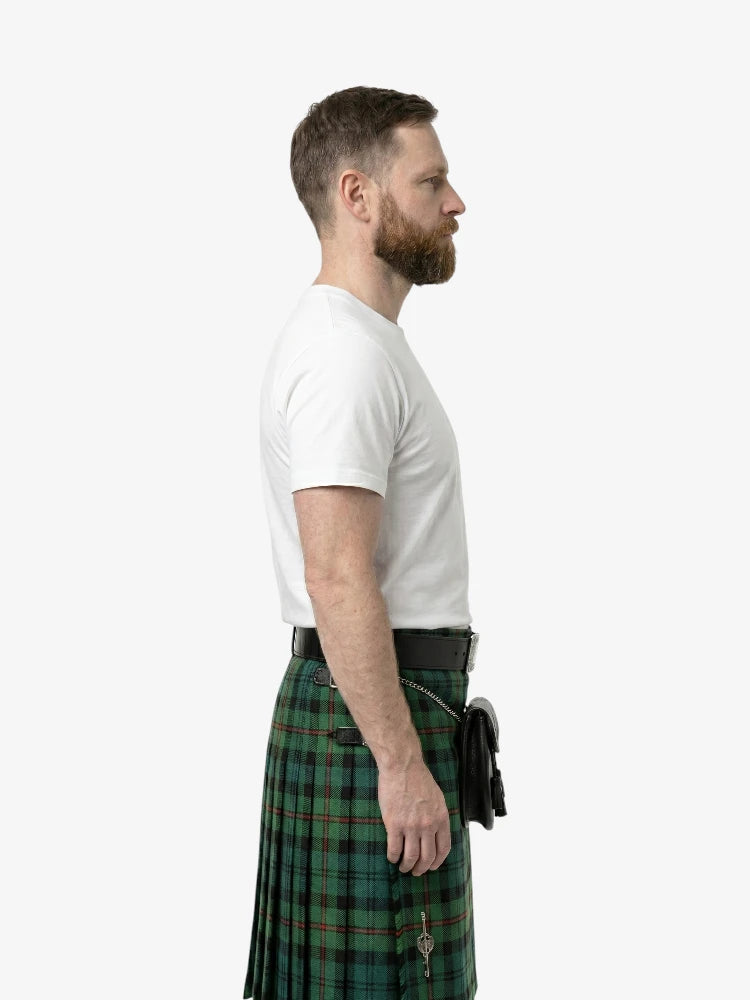 Man wearing a white t-shirt and green plaid kilt on a white background