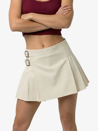 Person wearing a beige skirt with a white background