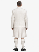 Person wearing a light-colored suit and pleated skirt on a white background