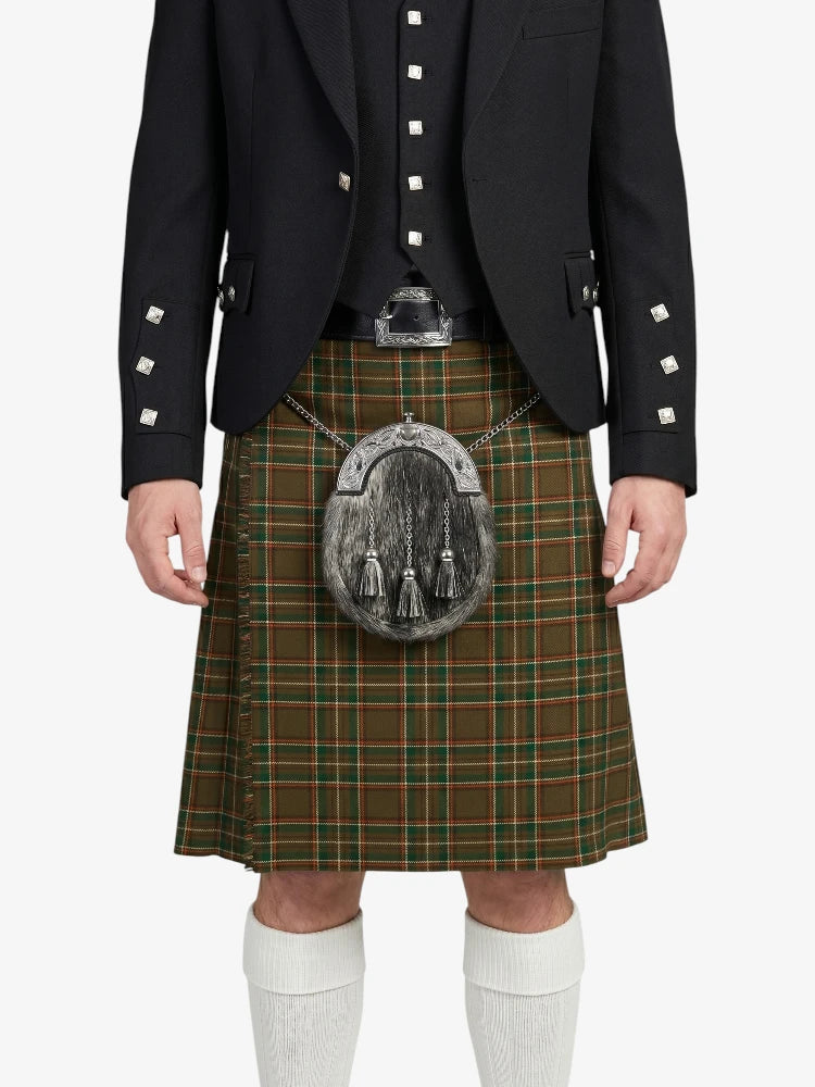 Person wearing a traditional Scottish kilt with a jacket on a white background