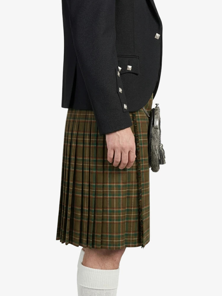 Person wearing a black jacket and green plaid kilt on a white background