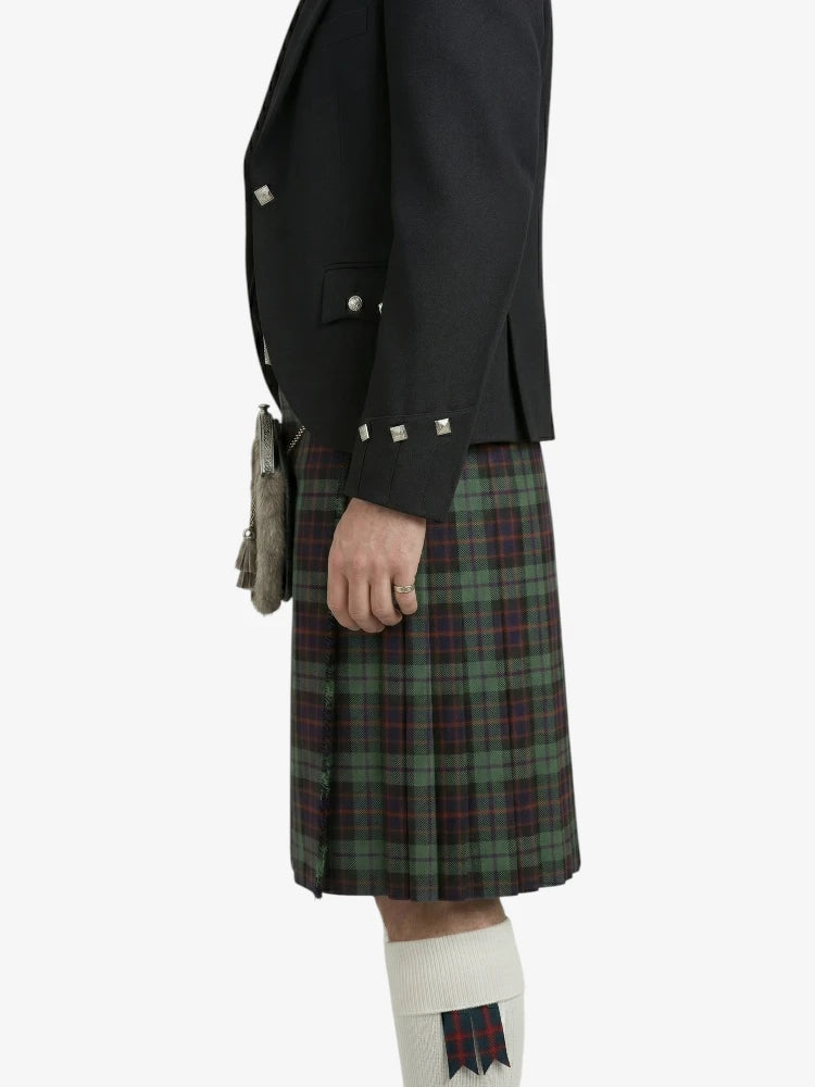 Person wearing a black jacket and green plaid kilt on a white background
