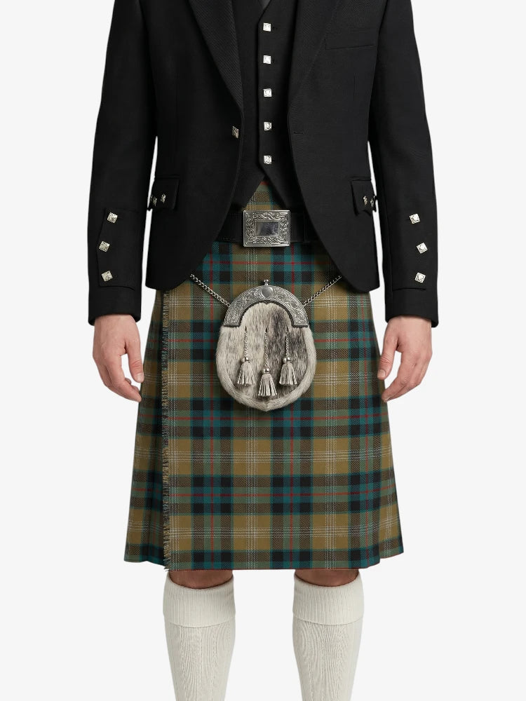 Person wearing a traditional Scottish kilt with a jacket on a white background