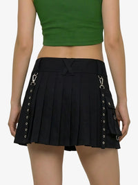 Black pleated skirt with silver buckles worn by a person on a white background