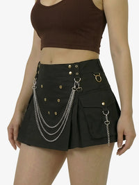 Black skirt with chain details worn by a person on a white background