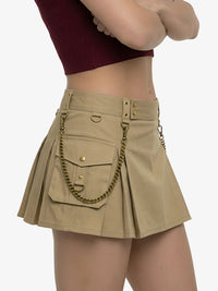 Beige skirt with gold chain detail worn by a person on a white background