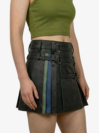 Person wearing a black leather skirt with colorful accents on a plain background