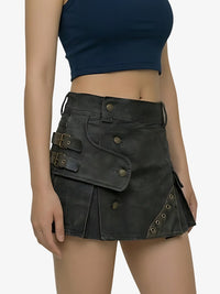 Black leather skirt with gold accents worn by a person on a plain background